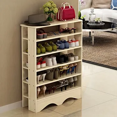 Freestanding white wooden shoe rack filled with shoes