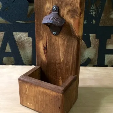 Handmade wooden bottle opener mounted on a wood board
