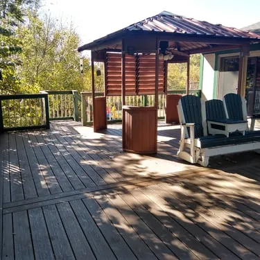 Wood deck with a covered seating area and outdoor furniture